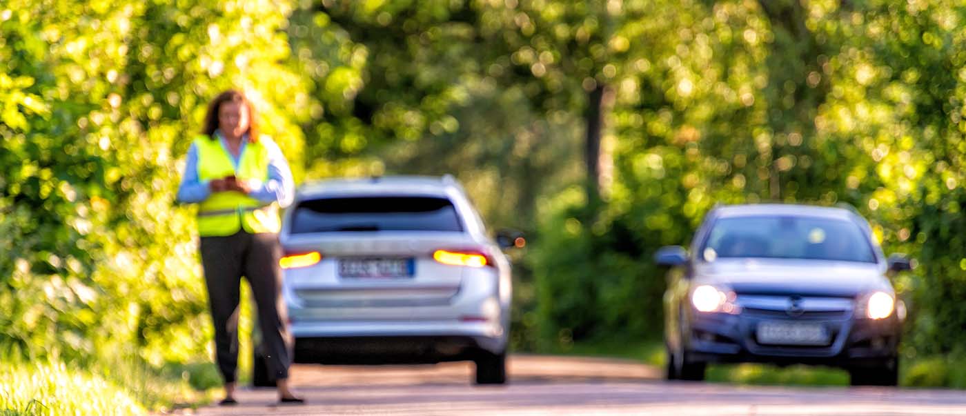 Roadside assistance coming to support a broken down vehicle on a country road. Roadside assistance coming to support a broken down vehicle on a country road.