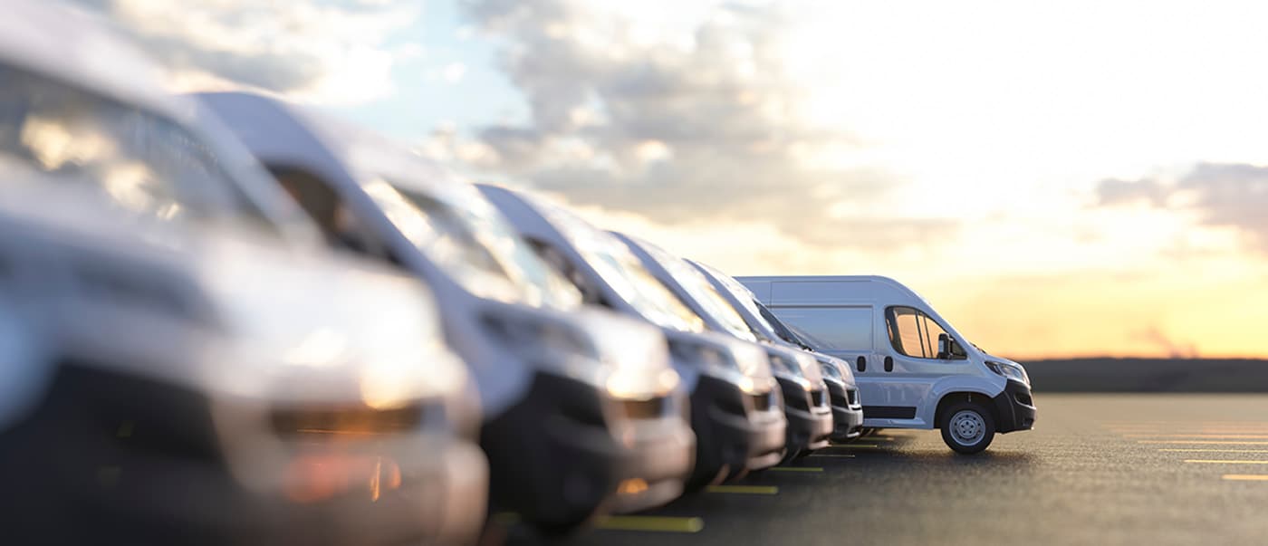Row of fleet vans in a parking bay. Row of fleet vans in a parking bay.