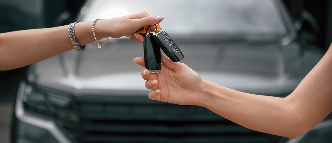Close up of a woman's hands receiving keys for a relief vehicle. Close up of a woman's hands receiving keys for a relief vehicle.