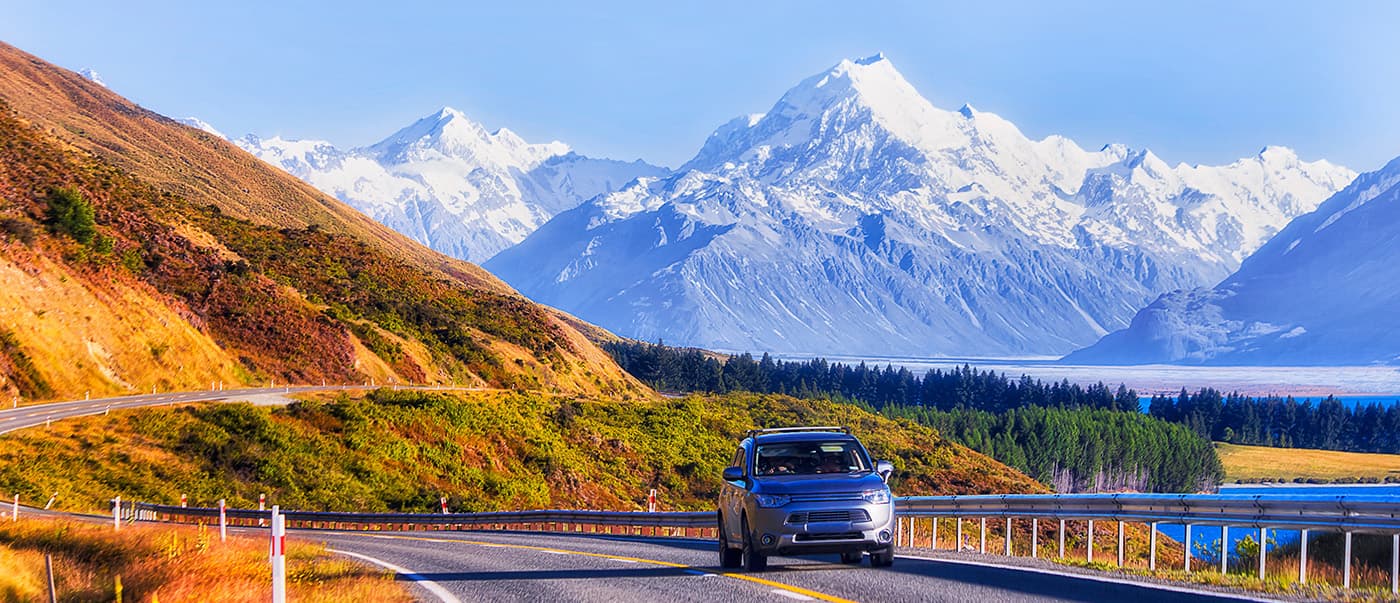 Passenger car on Highway 80 in New Zealand heading to Mt Cook national park. Passenger car on Highway 80 in New Zealand heading to Mt Cook national park.