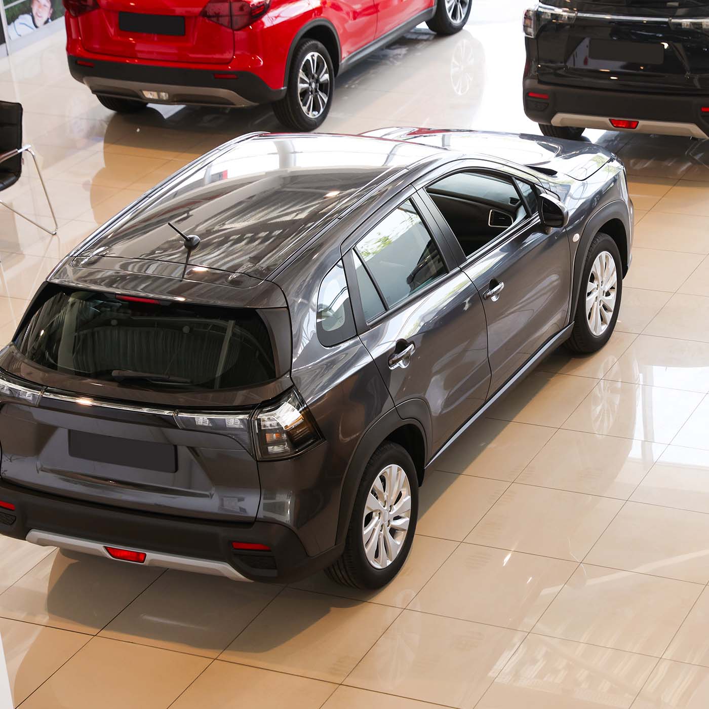 A group of new fleet vehicles in a showroom A group of new fleet vehicles in a showroom
