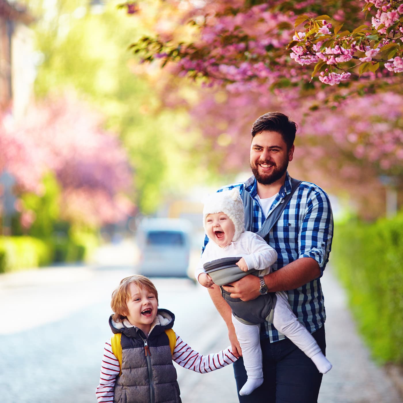 Happy father taking a walk with his children while on paternal leave. Happy father taking a walk with his children while on paternal leave.