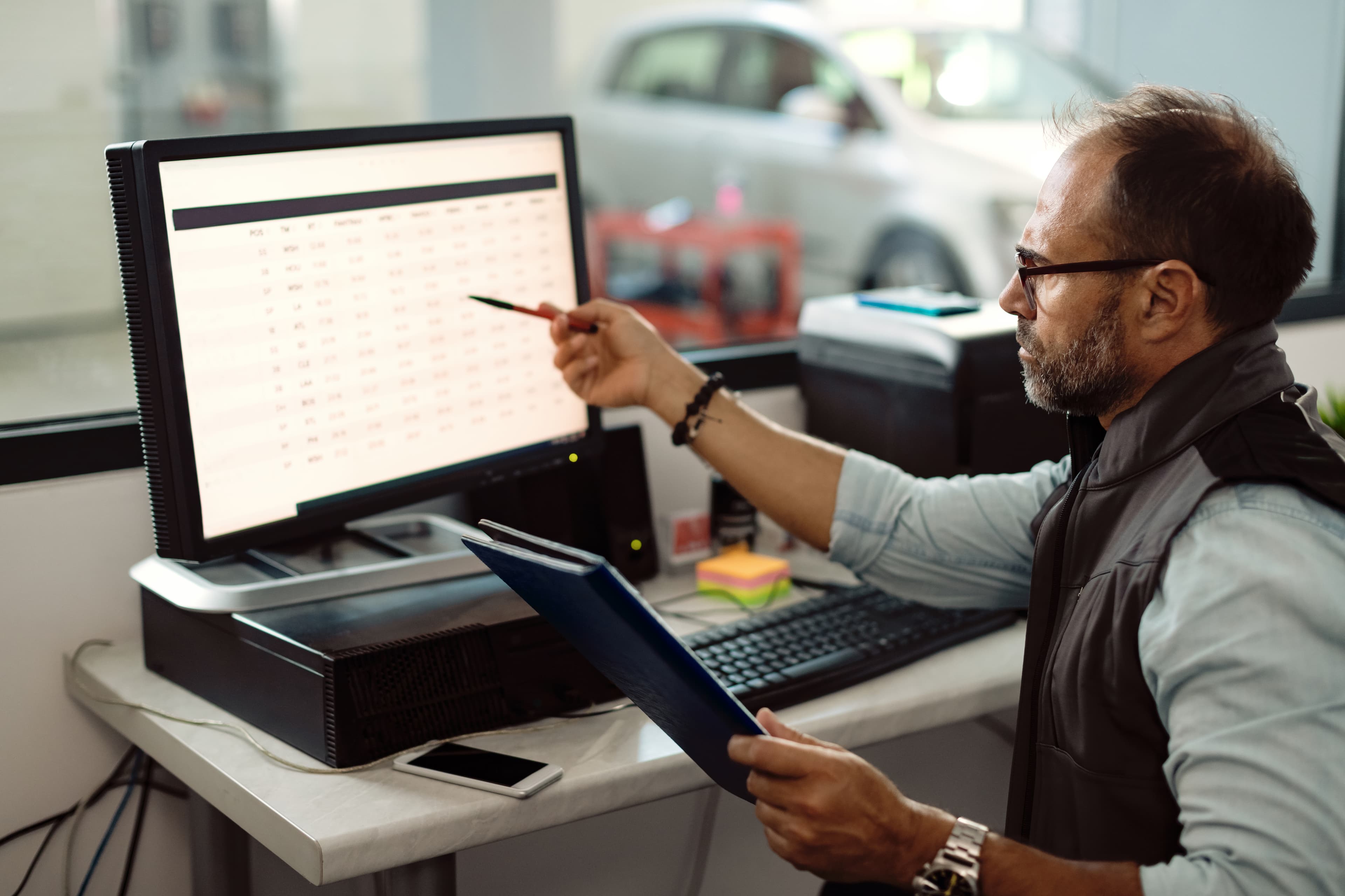 auto-mechanic-analyzing-reports-while-working-on-d-2024-12-13-20-14-57-utc auto-mechanic-analyzing-reports-while-working-on-d-2024-12-13-20-14-57-utc