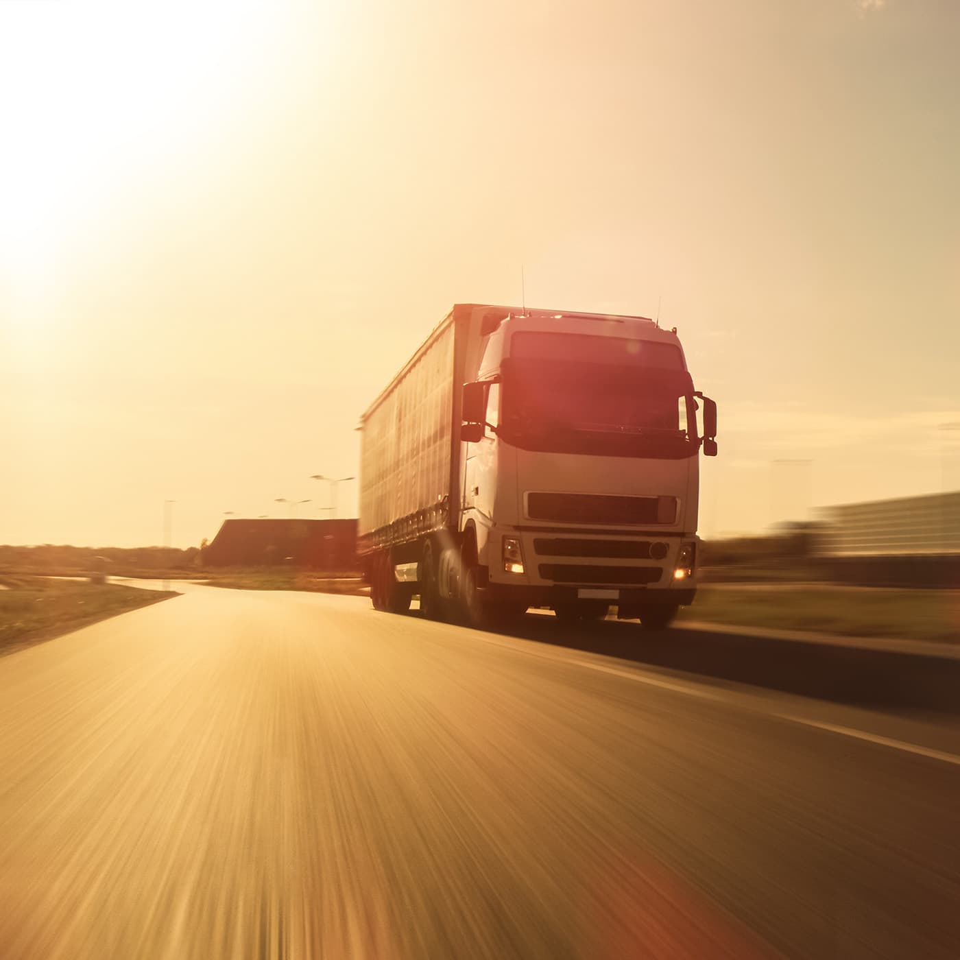 White semi truck with cargo trailer attached drives on an empty road. White semi truck with cargo trailer attached drives on an empty road.