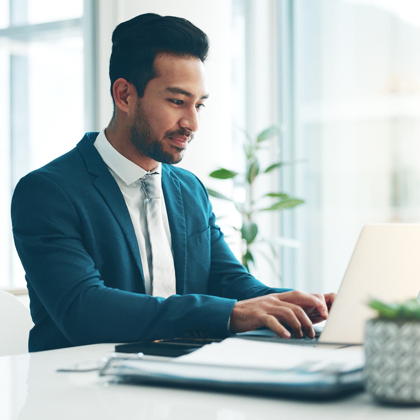 Consultant in a suit working on a laptop to manage tolls and infringements for a customer. Consultant in a suit working on a laptop to manage tolls and infringements for a customer.