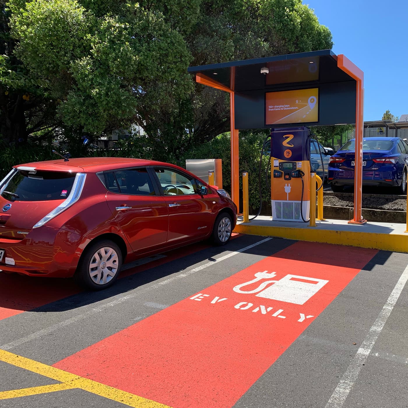 An electric vehicle charges at a Z Station, seamlessly integrating eco-friendly travel into everyday driving routines in the city. An electric vehicle charges at a Z Station, seamlessly integrating eco-friendly travel into everyday driving routines in the city.
